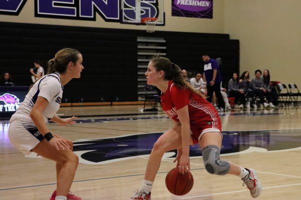 Senior point guard Miranda Sibley dribbles against a defender to set up the team’s offensive play.