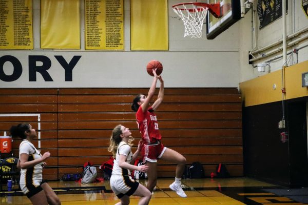 Junior Haleh Ansari leaps to score a fastbreak layup during the team's last league game on Friday, Feb. 14.