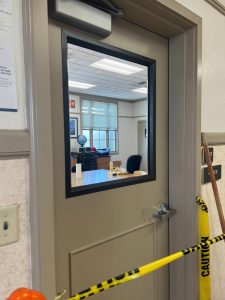 Blocked off science office door with broken window cleaned out. 
Photo credits