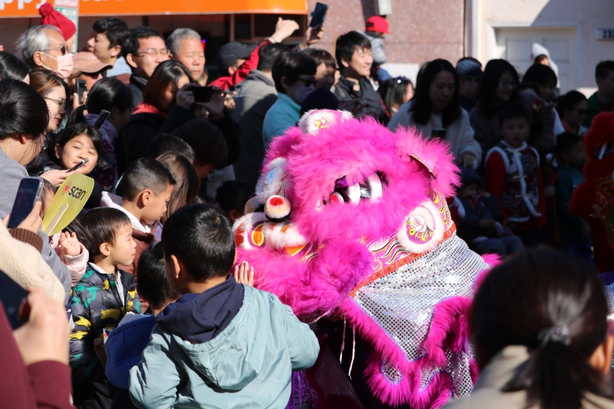 The signature lion dance is performed during Lunar New Year to scare off demons. In Chinese culture, stroking the lion's head blesses people with extra luck and prosperity.