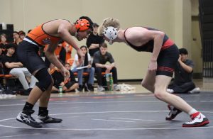 Junior Miles Reeth faces off with his San Mateo opponent Ricky Gomez at the start of the period.