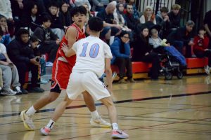 Junior point guard Jean-Luc Uharriet scans the court and looks for an open teammate. 