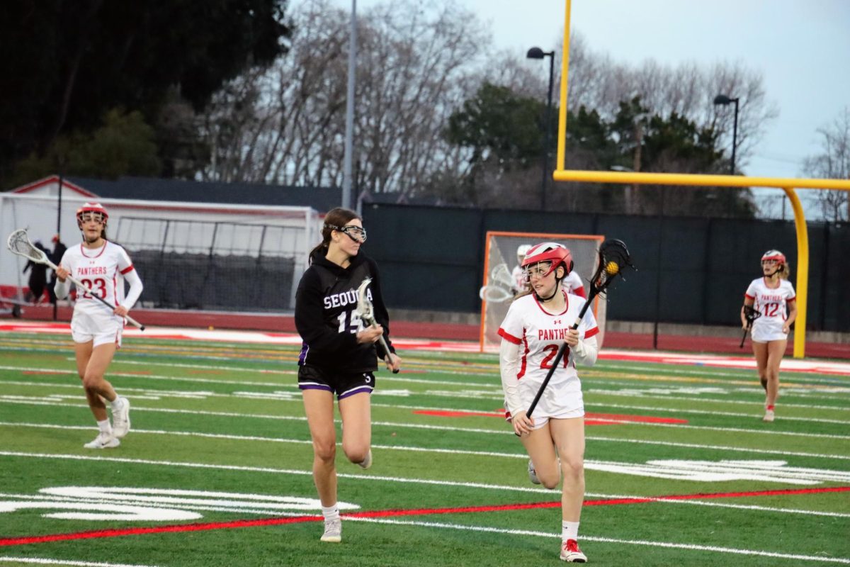 Senior midfielder and co-captain Miranda Sibley drives down the field, keeping possession as she looks for an opening. 