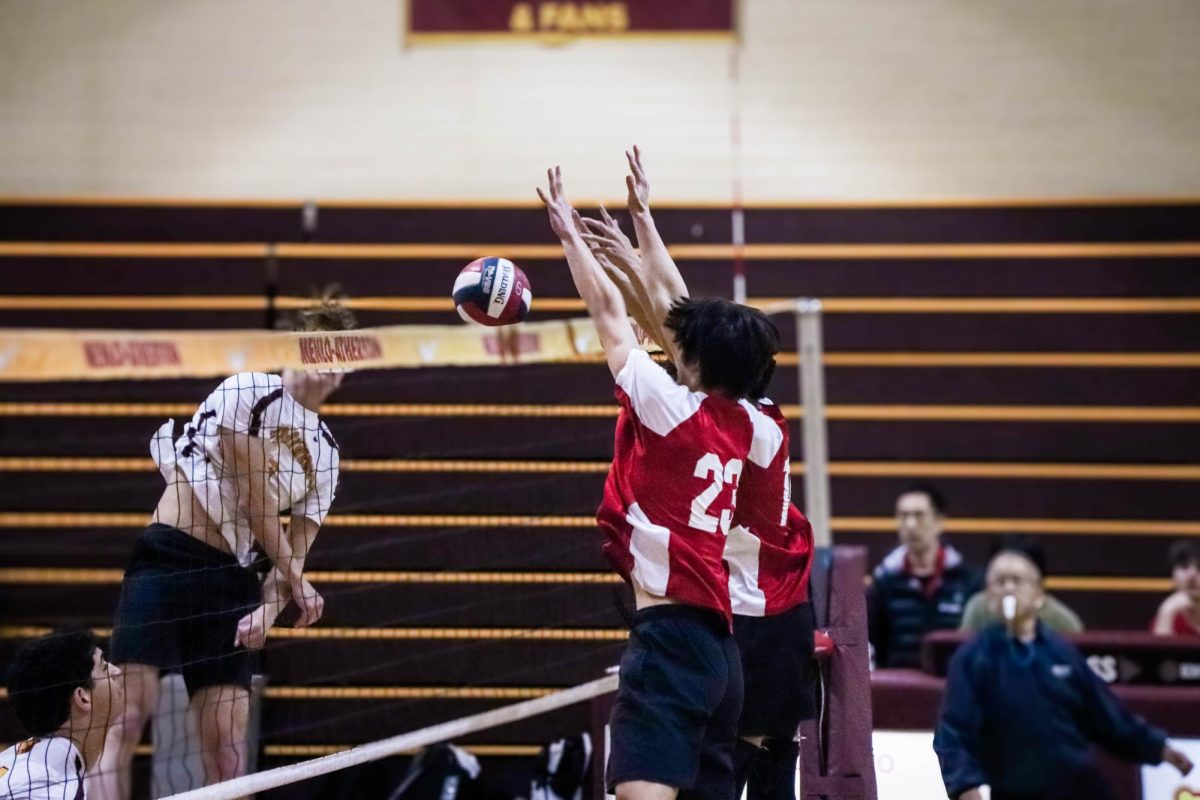 Senior Cole Ng and sophomore Julian Lee block an attack from Menlo-Atherton High School during the match on Friday, March 14.