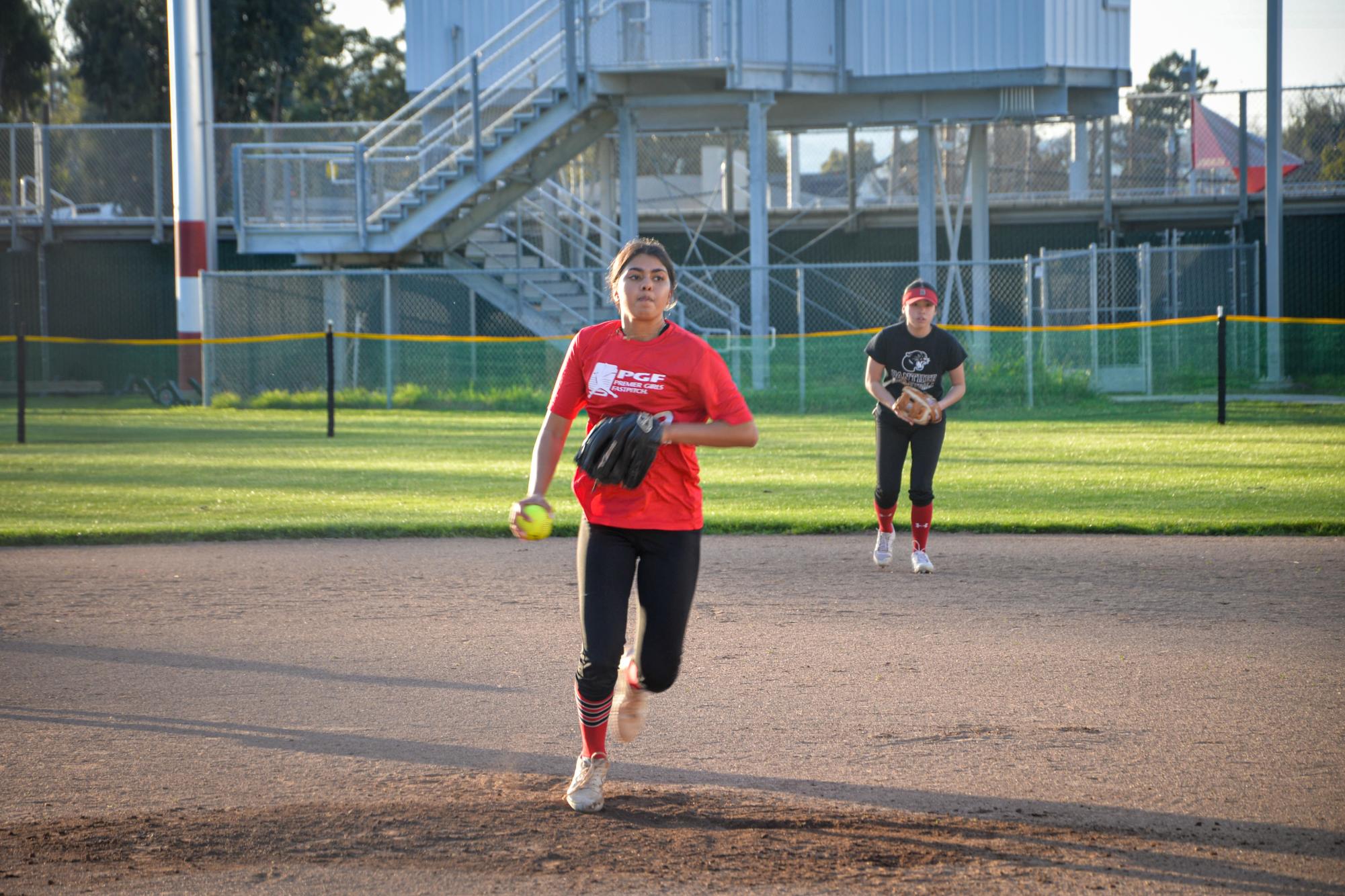 Sophomore Aditi Bafna pitches to a batter during varsity softball’s scrimmage versus the junior varsity team on Thursday, Feb. 27.