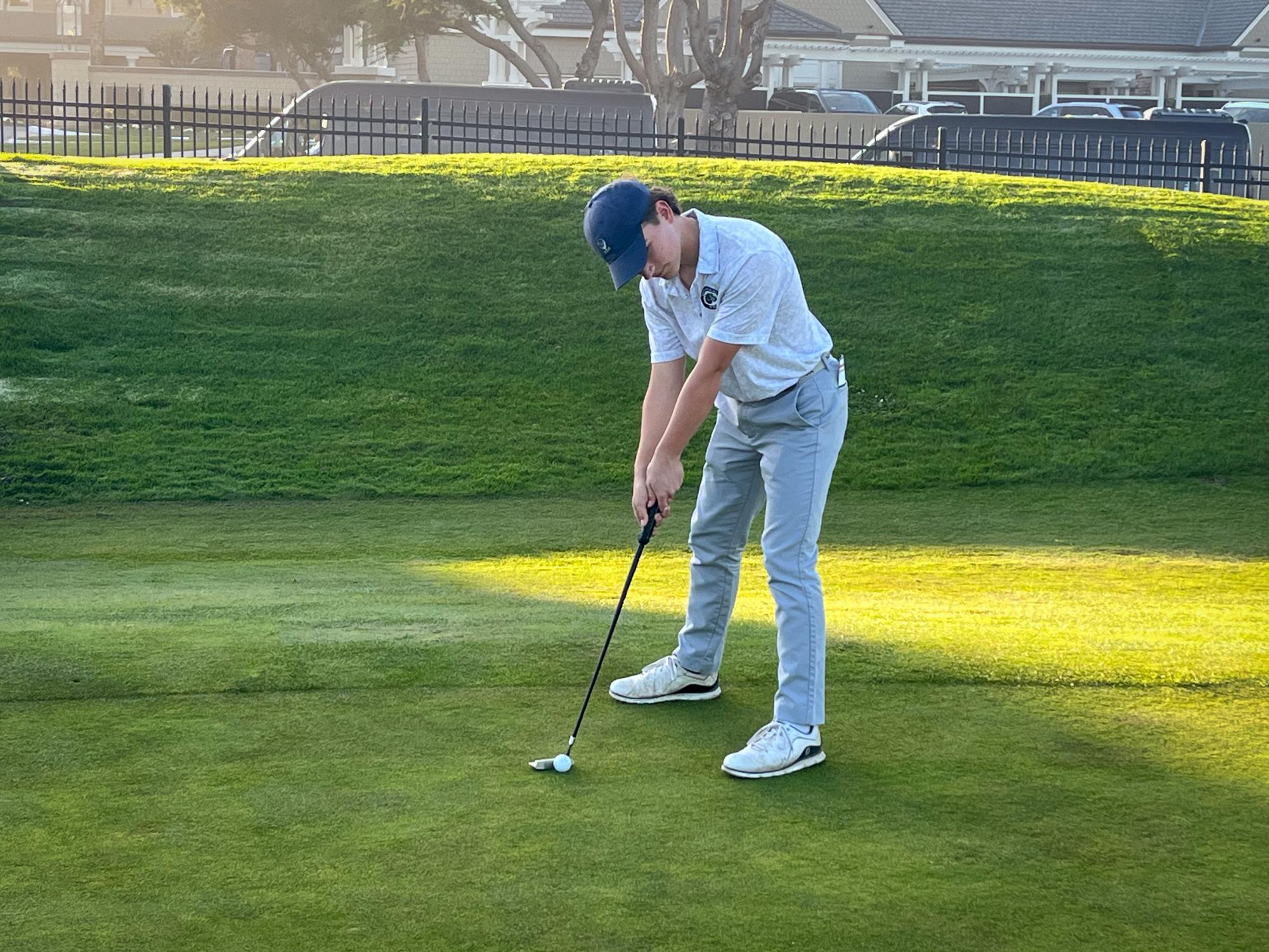 Junior Ethan Cyb looks over his putt during the team’s practice match on Thursday, Feb. 27 at Half Moon Bay Golf Links.  