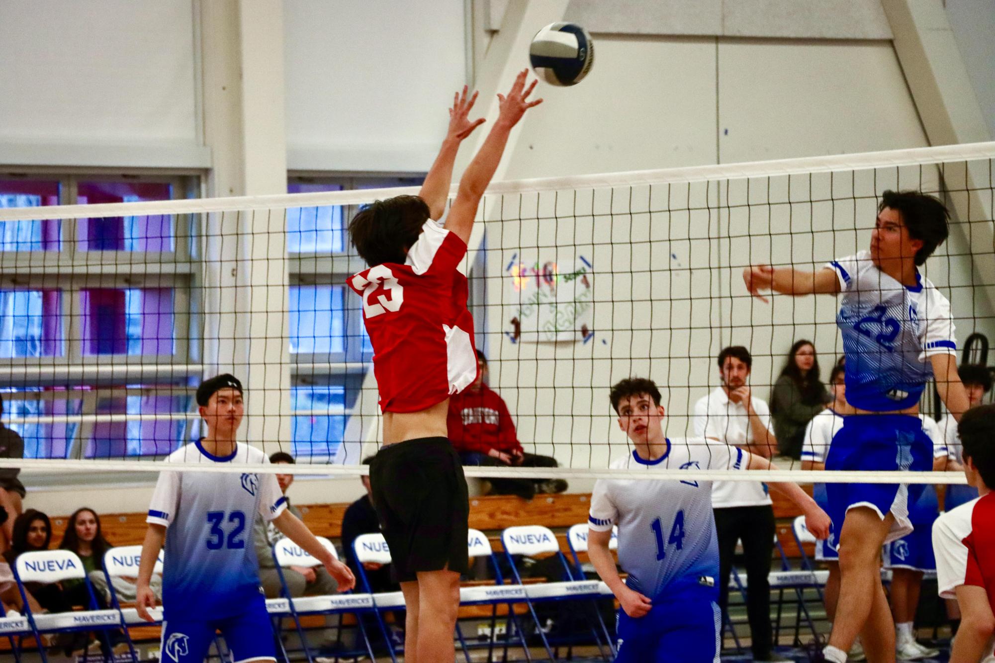 Sophomore Julian Lee blocks an attack from The Nueva School during their match on Thursday, Feb. 27.