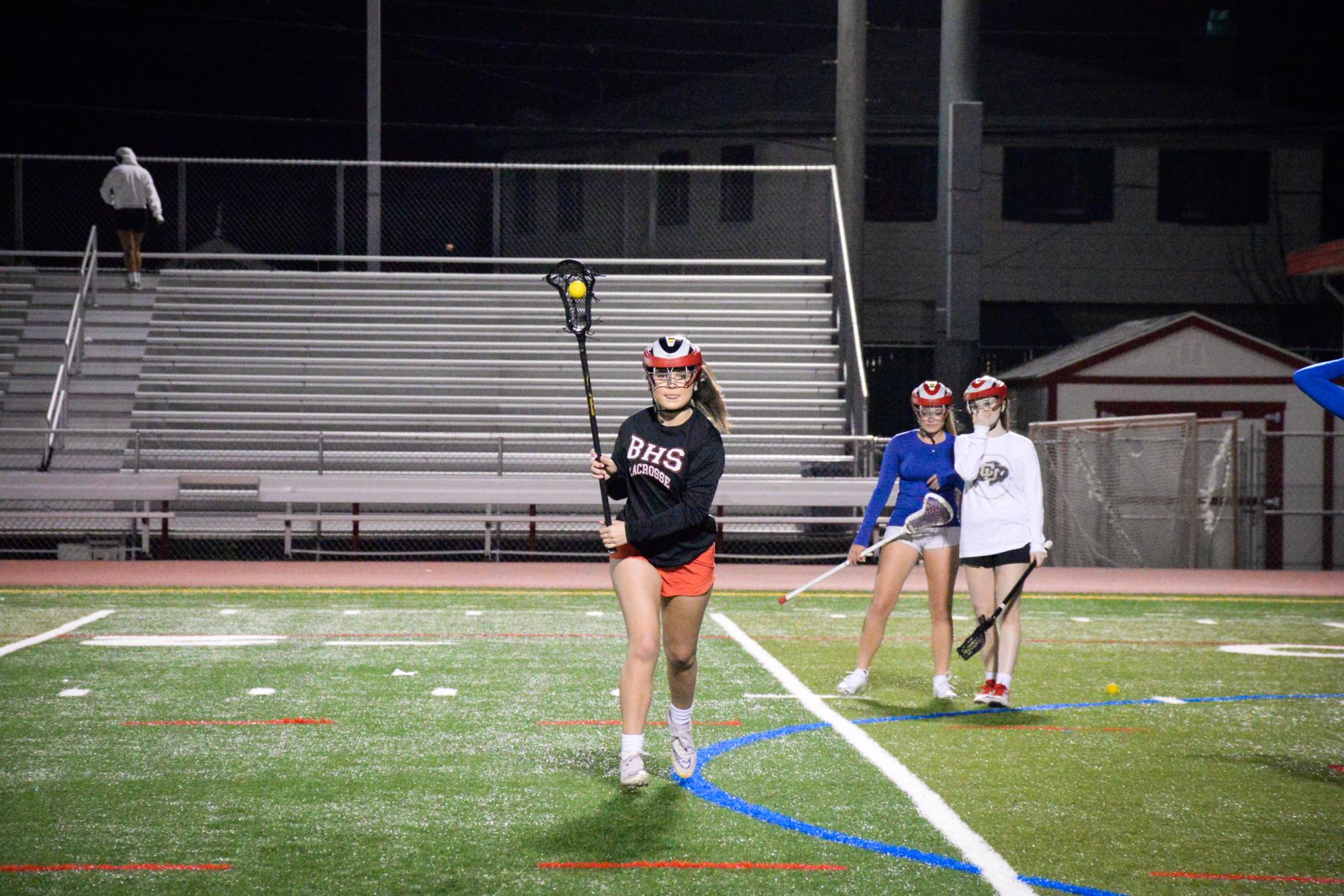 Varsity defender junior Katie Jarrett looks to pass during a practice.