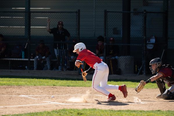 Junior Grayson Howard lays a bunt down the third base line.