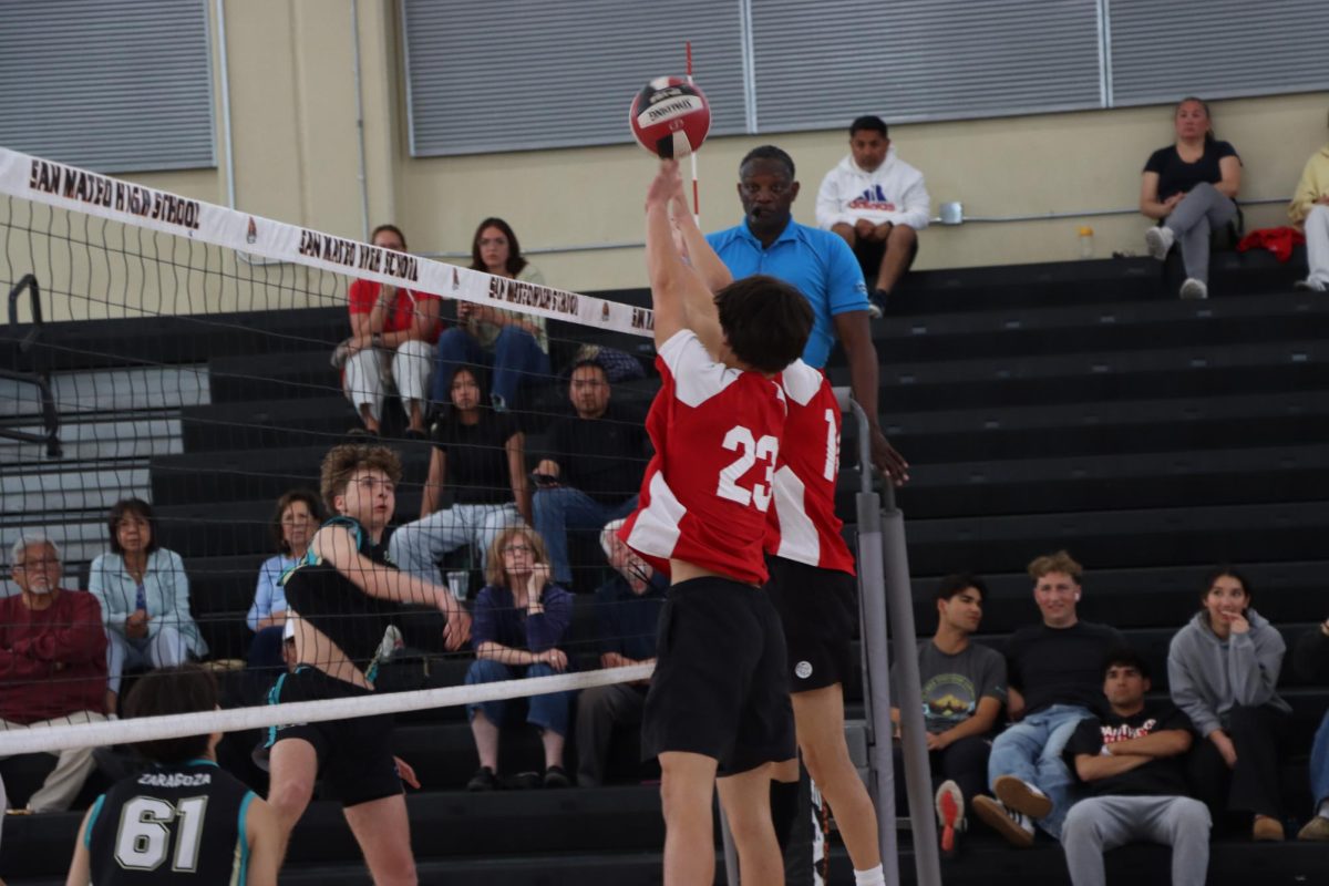 Seniors CJ Reed and Cole Ng block an attack from Christopher during a match on Monday, May 12.