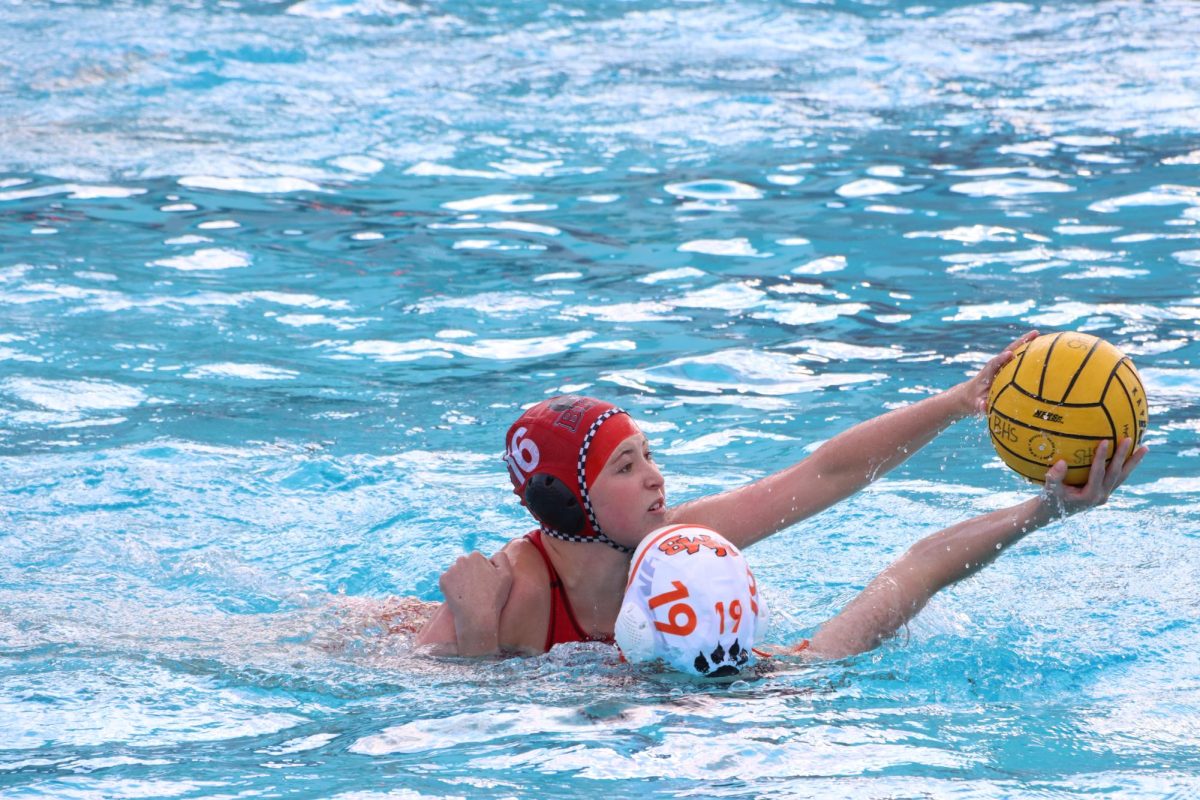 Sophomore Julia Bowler and a Half Moon Bay High School player fight for possession of the ball.