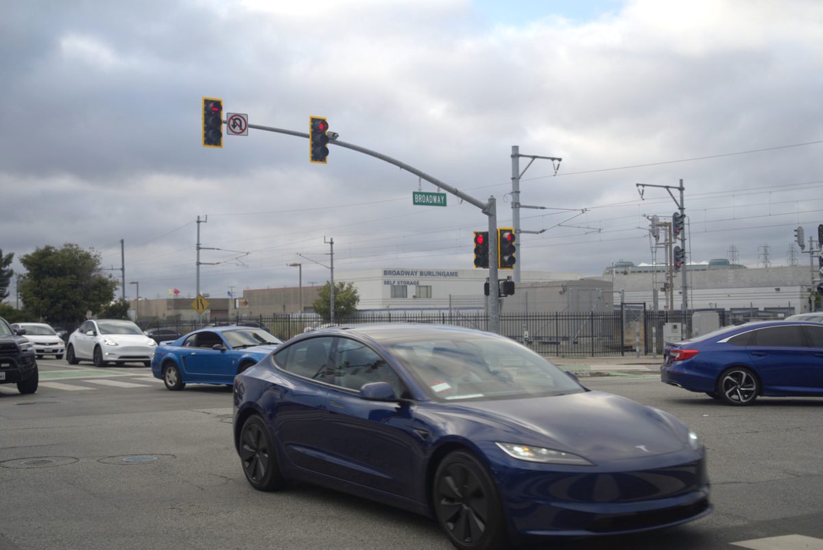 A stream of cars moves through the Broadway intersection, with some turning left to cross the train tracks onto Carolan Avenue. Broadway and Carolan Avenue are both hotspots on a Vision Zero, and the organization’s winter proposal is expected to address these and other safety concerns.