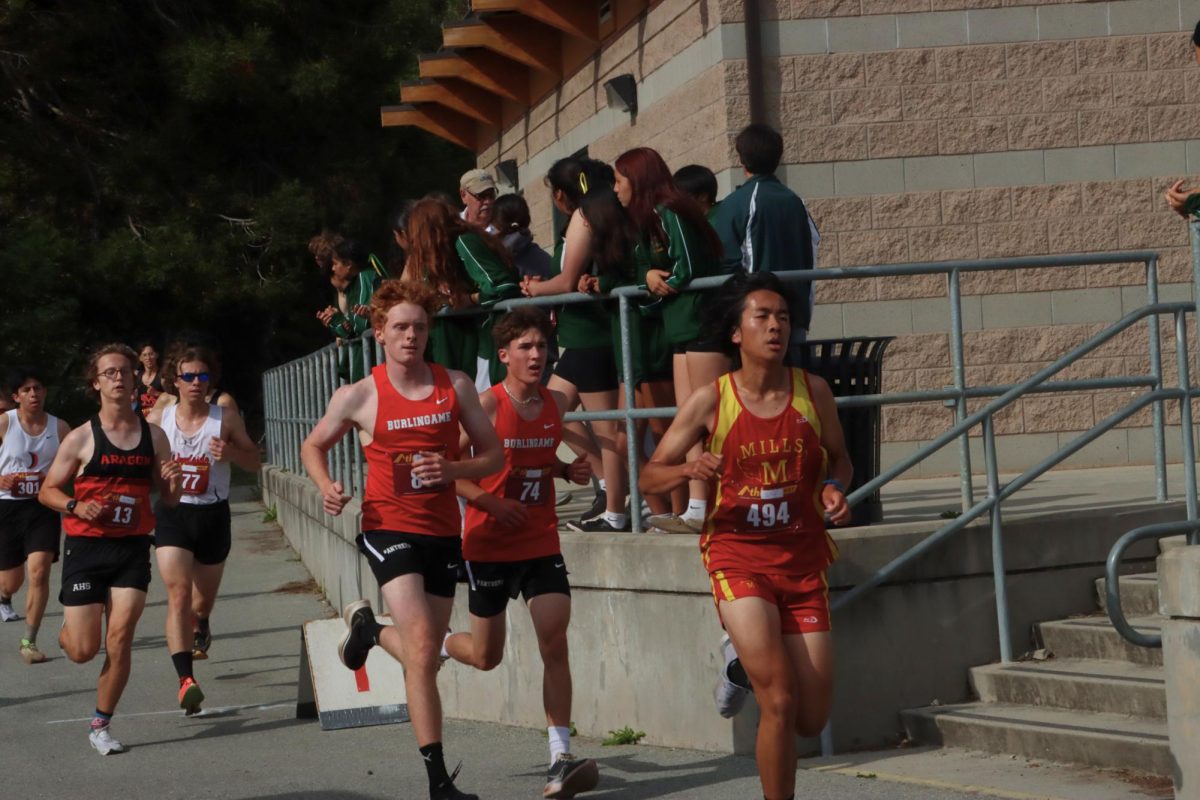 Juniors Tad Folgner and Aiden Dille run together, pacing each other to strong finishes.