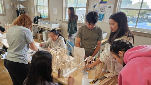 Architecture students collaborate to build intricate structures.
