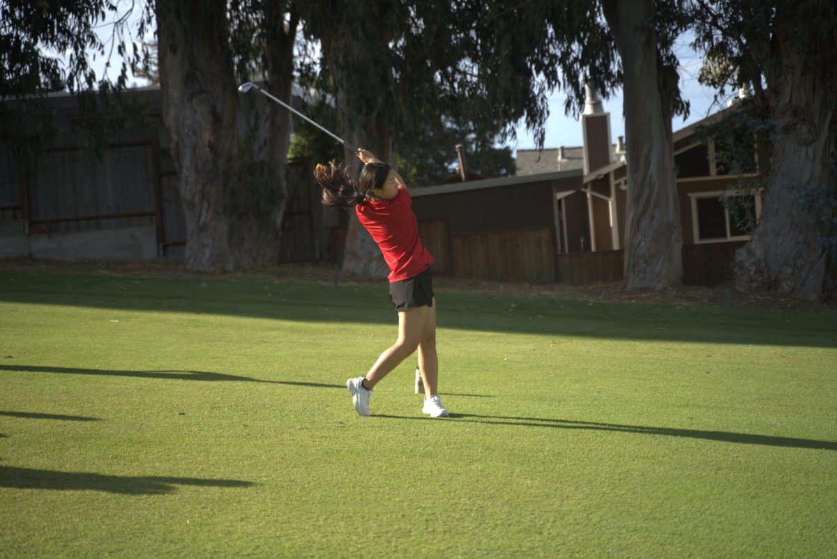 Freshman Judy Hu makes a stroke on the second-to-last hole of the Green Hills golf green during their game against Capuchino High School on Wednesday, Sept. 24.