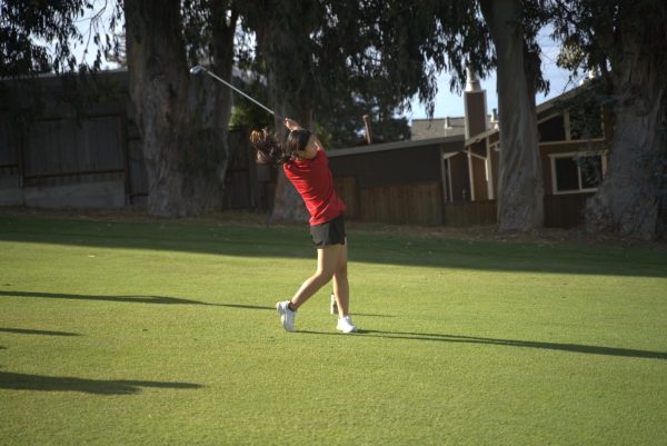 Freshman Judy Hu makes a stroke on the second-to-last hole of the Green Hills golf green during their game against Capuchino High School on Wednesday, Sept. 24.