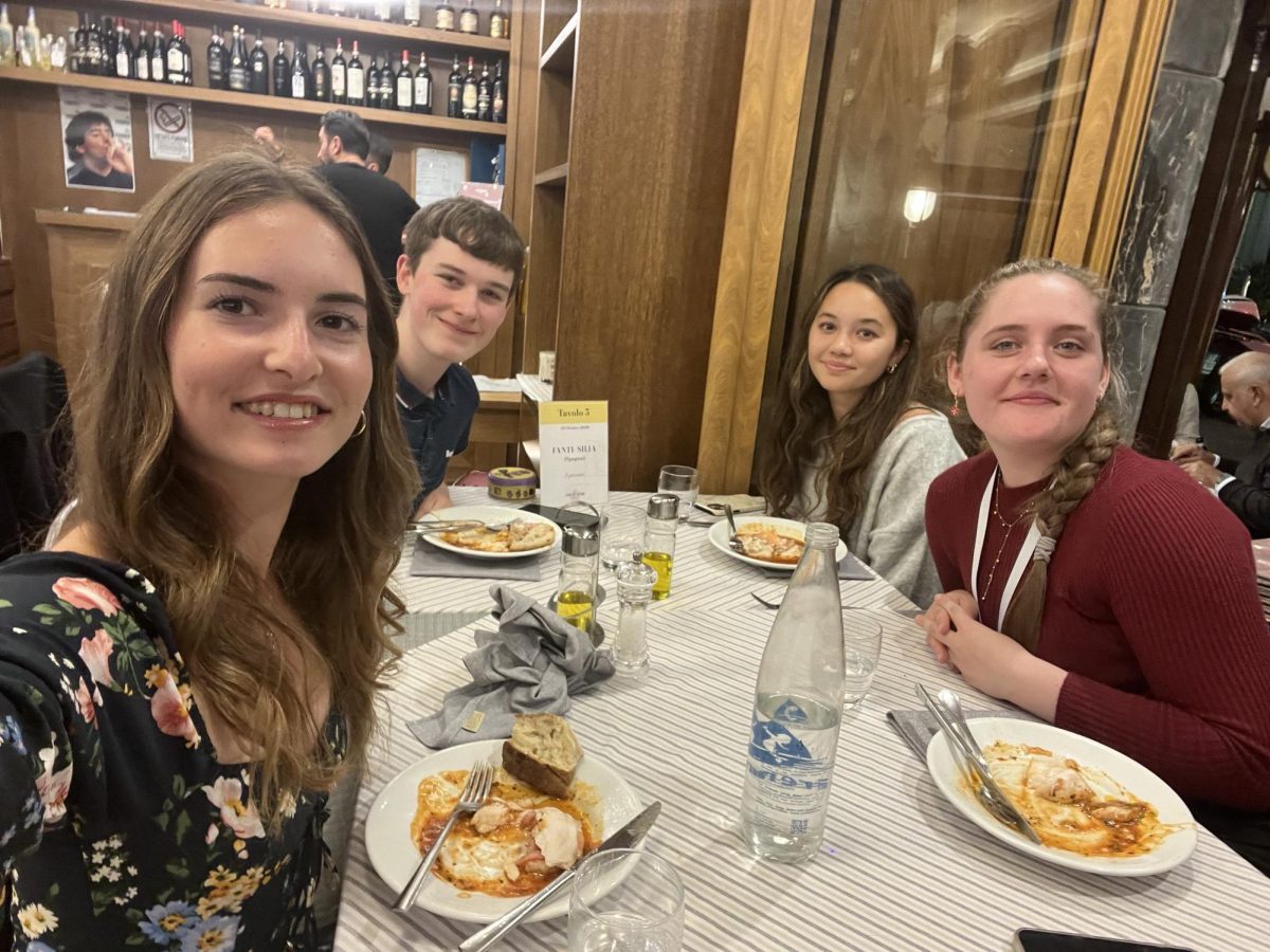 The two Burlingame delegates dine at a restaurant with students from the U.K. who are also on the trip.