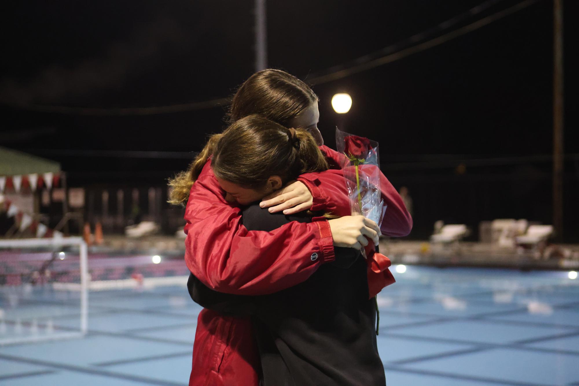 Senior Maddie Rothstein shares an embrace with sophomore Ari Beser after Beser gave a heartfelt speech to honor Rothstein on senior night.