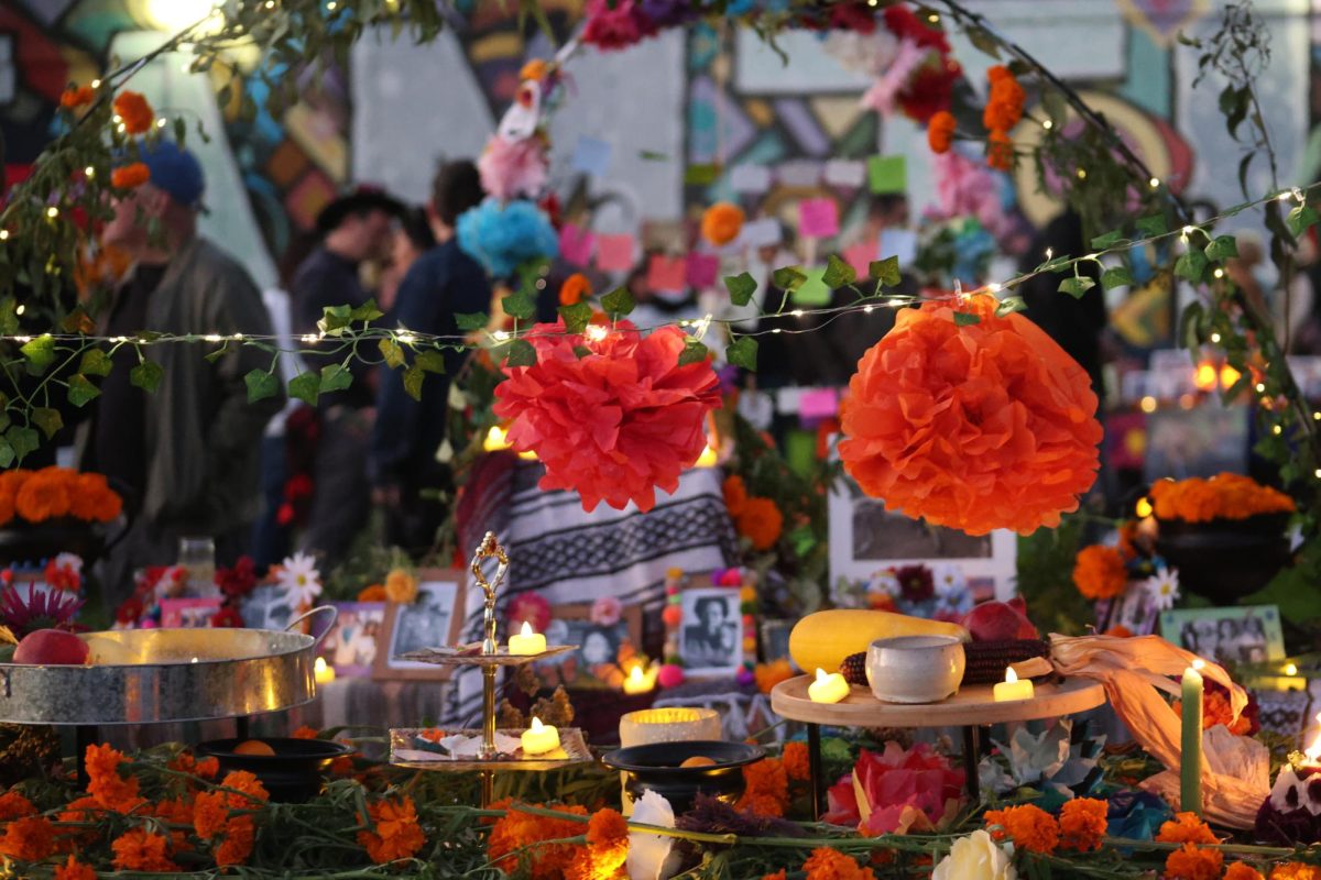 Marigold flowers are strung up on a line over an altar.