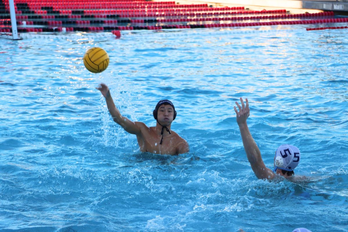 Senior Adrian Gong passes the ball to his teammate.