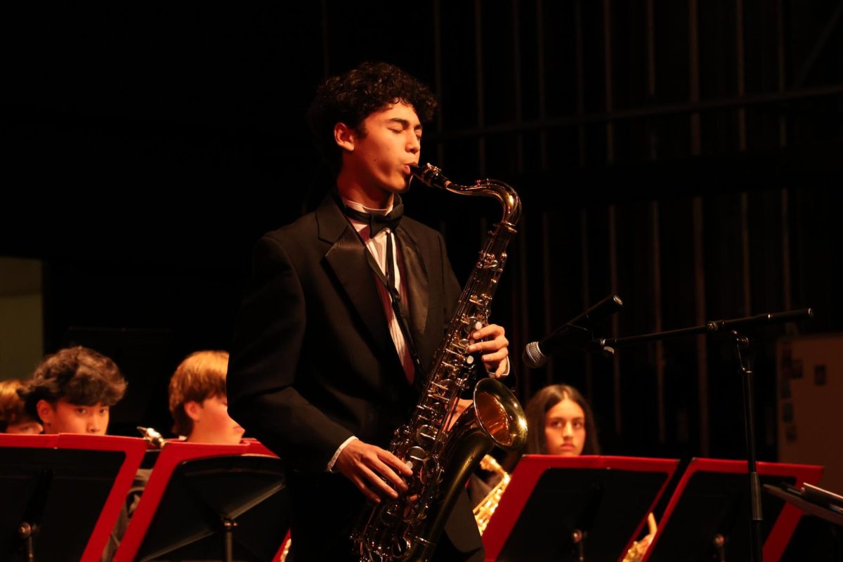 Junior tenor saxophonist Colin Haine performs a solo during “Seven Steps to Heaven” for the jazz ensemble.