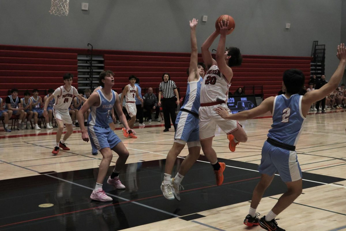 Senior Payton Fong Heady goes for a layup against a Hillsdale High School defender.