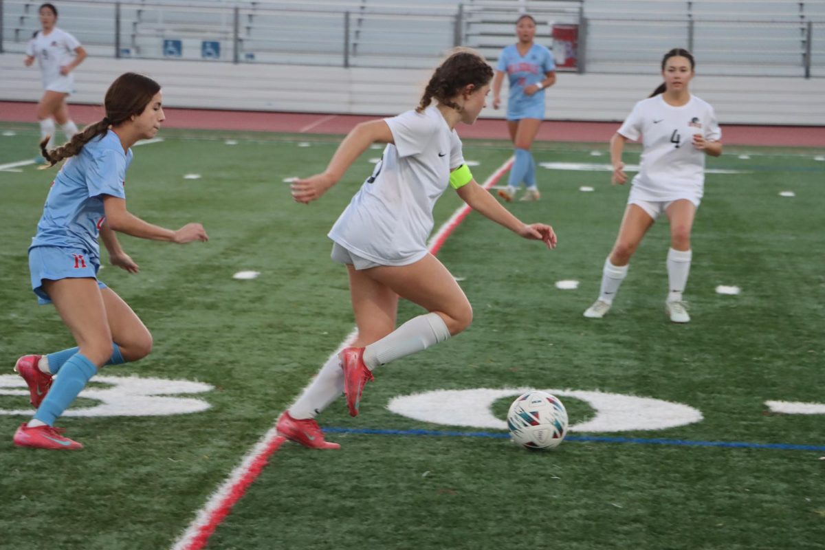 Senior and co-captain Gaelle-Anne Foy runs after the ball to pass to a teammate.
