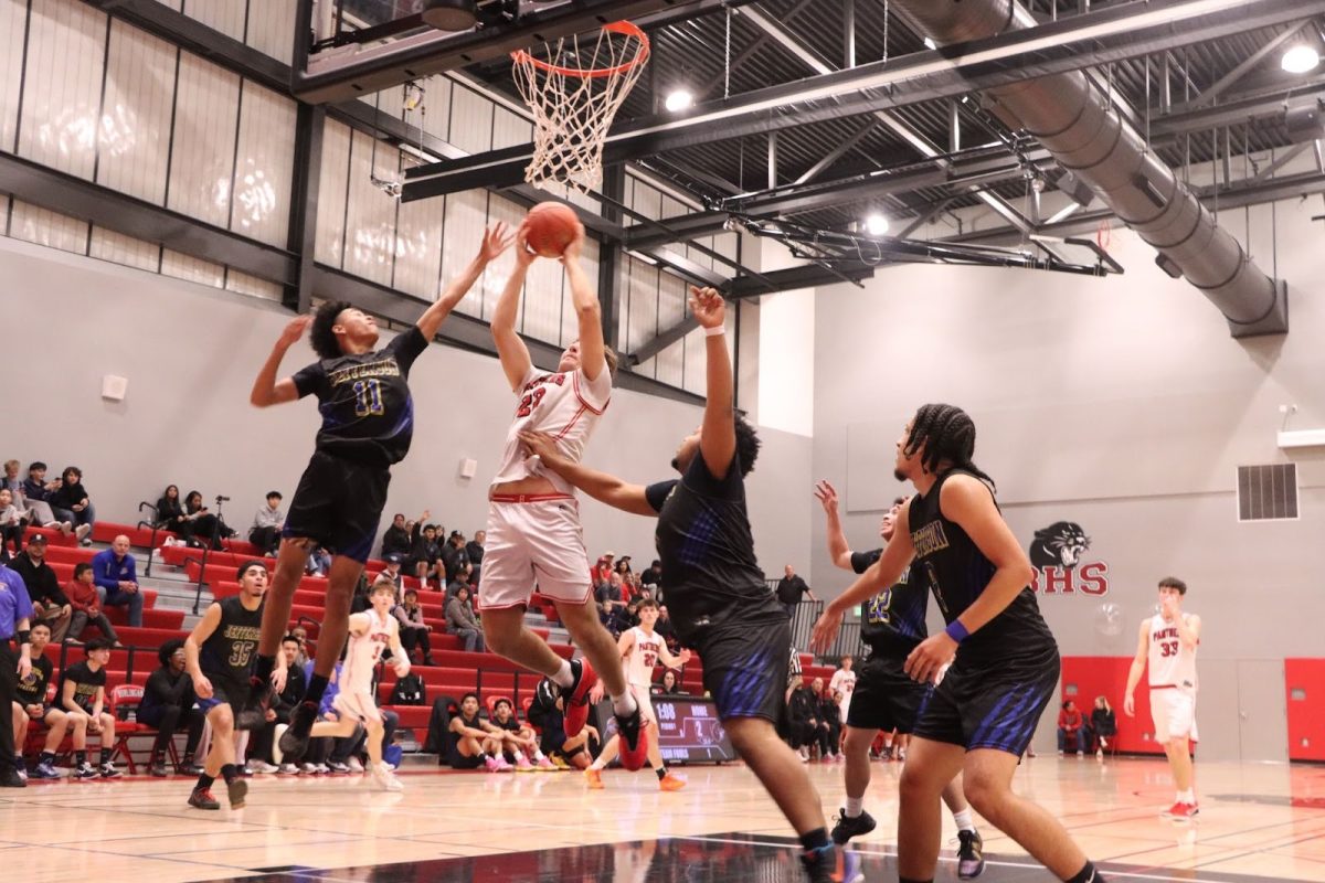 Junior power forward David Parrot goes for a bank shot against the defense.