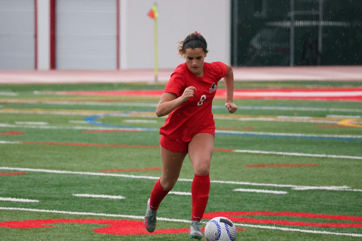 Senior Avery Speight runs with the ball, preparing to pass to a teammate.