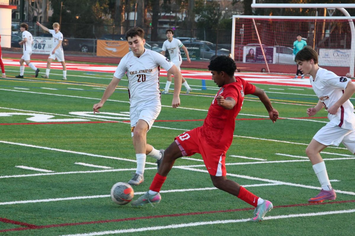 Junior midfielder Ayaan Palaniappan keeps control of the ball from the opposing team.
