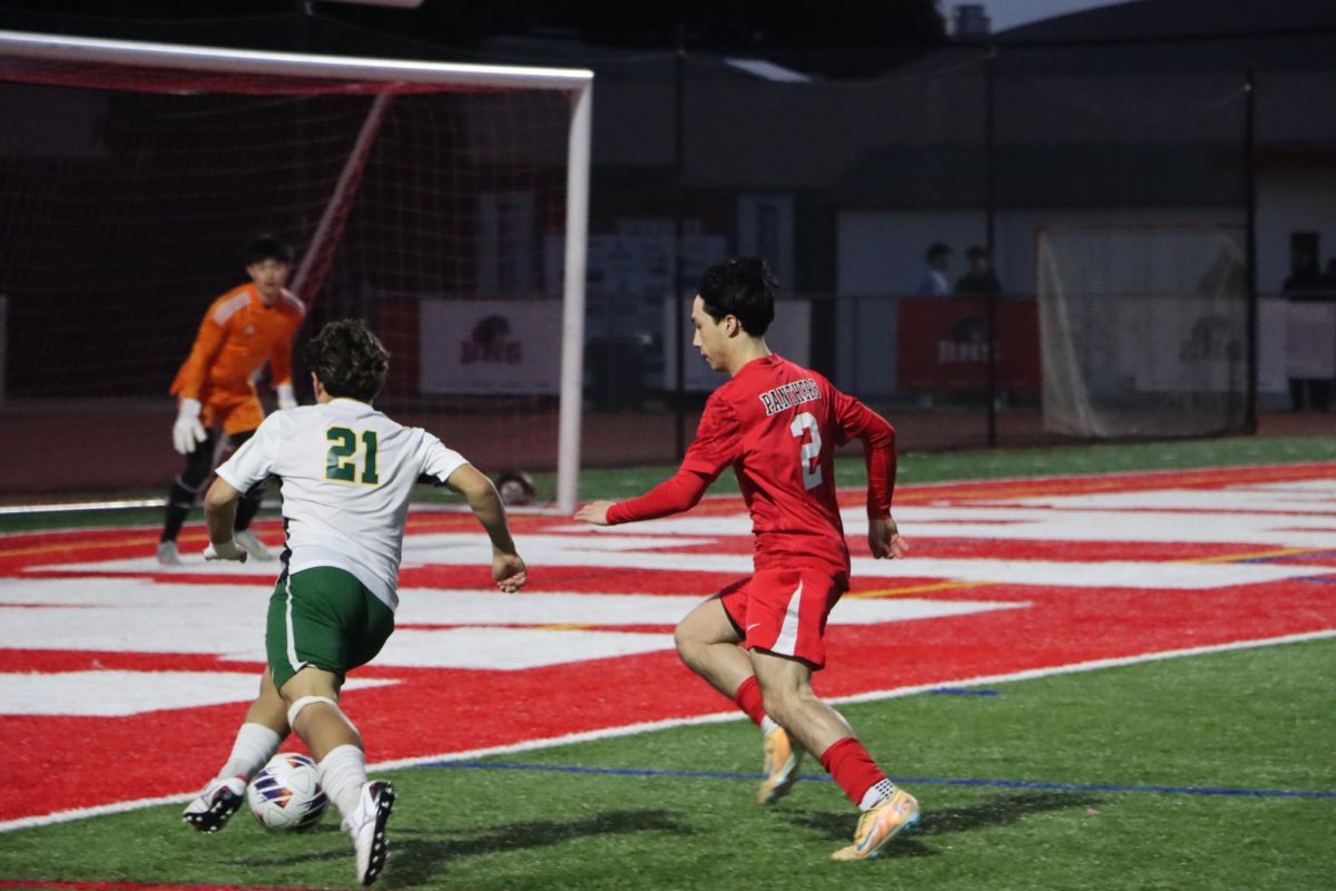 Senior right back Jack Clarke attempts to stop an opposing player from scoring.