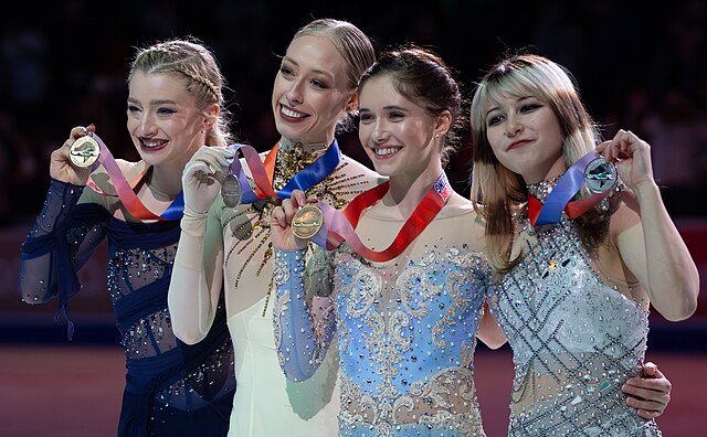  Figure skaters Amber Glenn, Bradie Tennell, Isabeau Levito, and Alysa Liu celebrate their medals. Photo courtesy of SpiritedMichelle, CC BY 4.0 via Wikimedia Commons