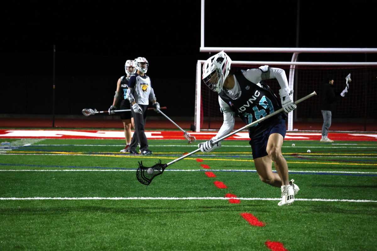 Senior Lucas Kim cradles the ball during a technical drill.