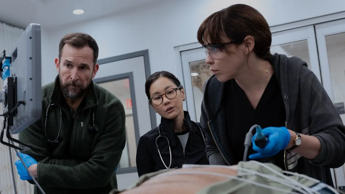 Dr. Michael “Robby” Robinavitch (Noah Wyle), medical student Joy Kwon (Irene Choi), and Dr. Cassie McKay (Fiona Dourif) treat a patient together. Photo courtesy of Warner Bros. Studios