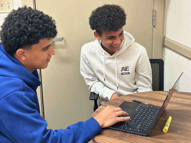 Junior Qasim Abutair helps freshman Shaban Hassan with his homework.