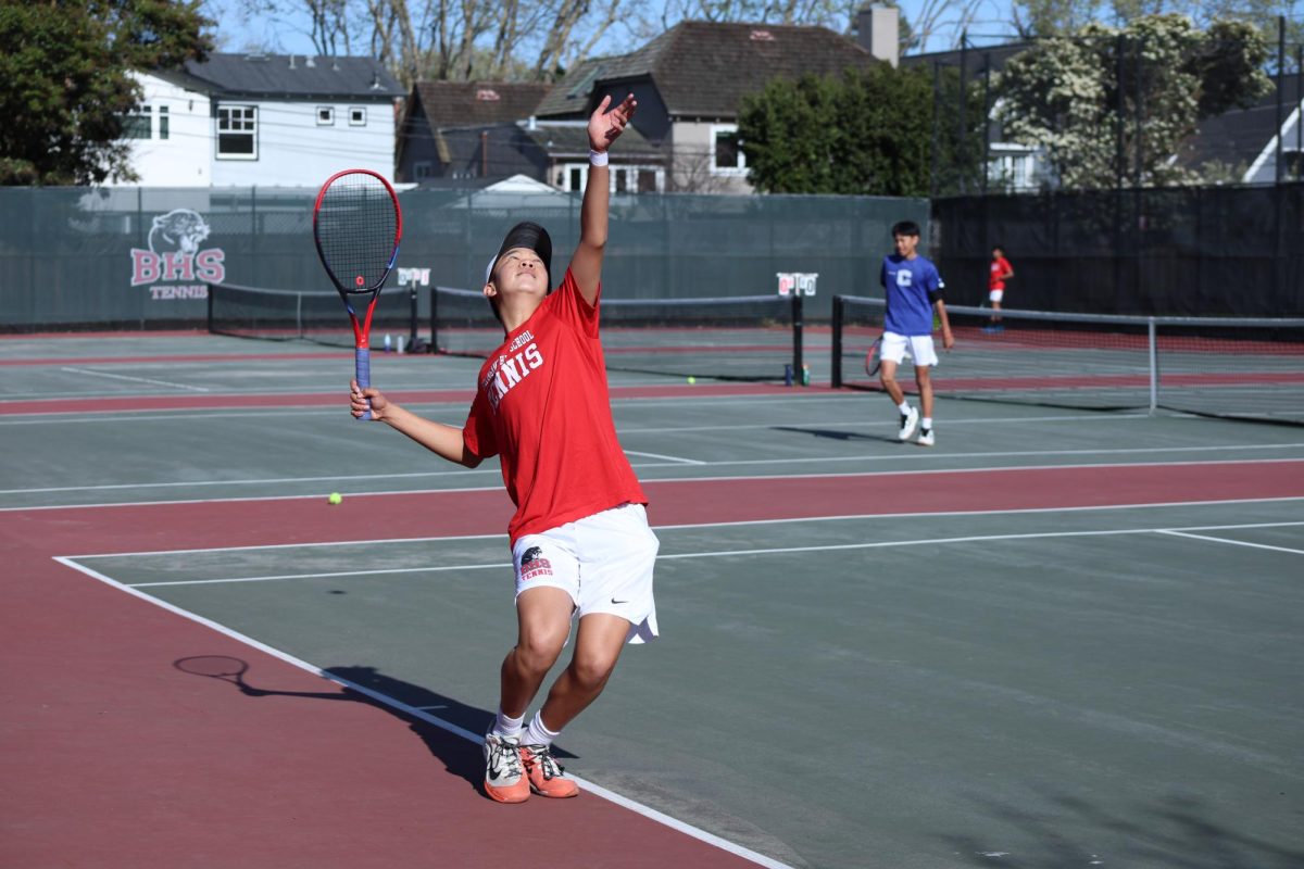 Sophomore Kaden Lam serves the ball to his opponent in his No.1 singles match.