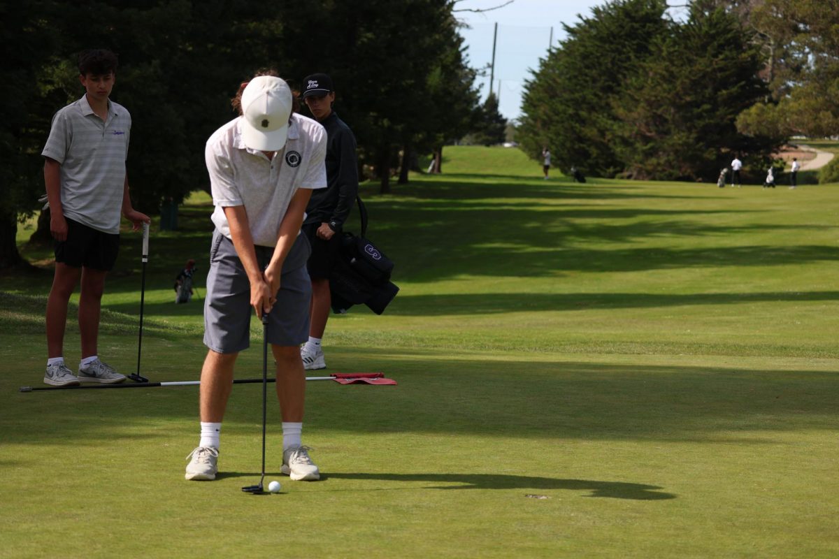 Senior Ethan Cyb, the No. 1 player on the team, focuses on putting.