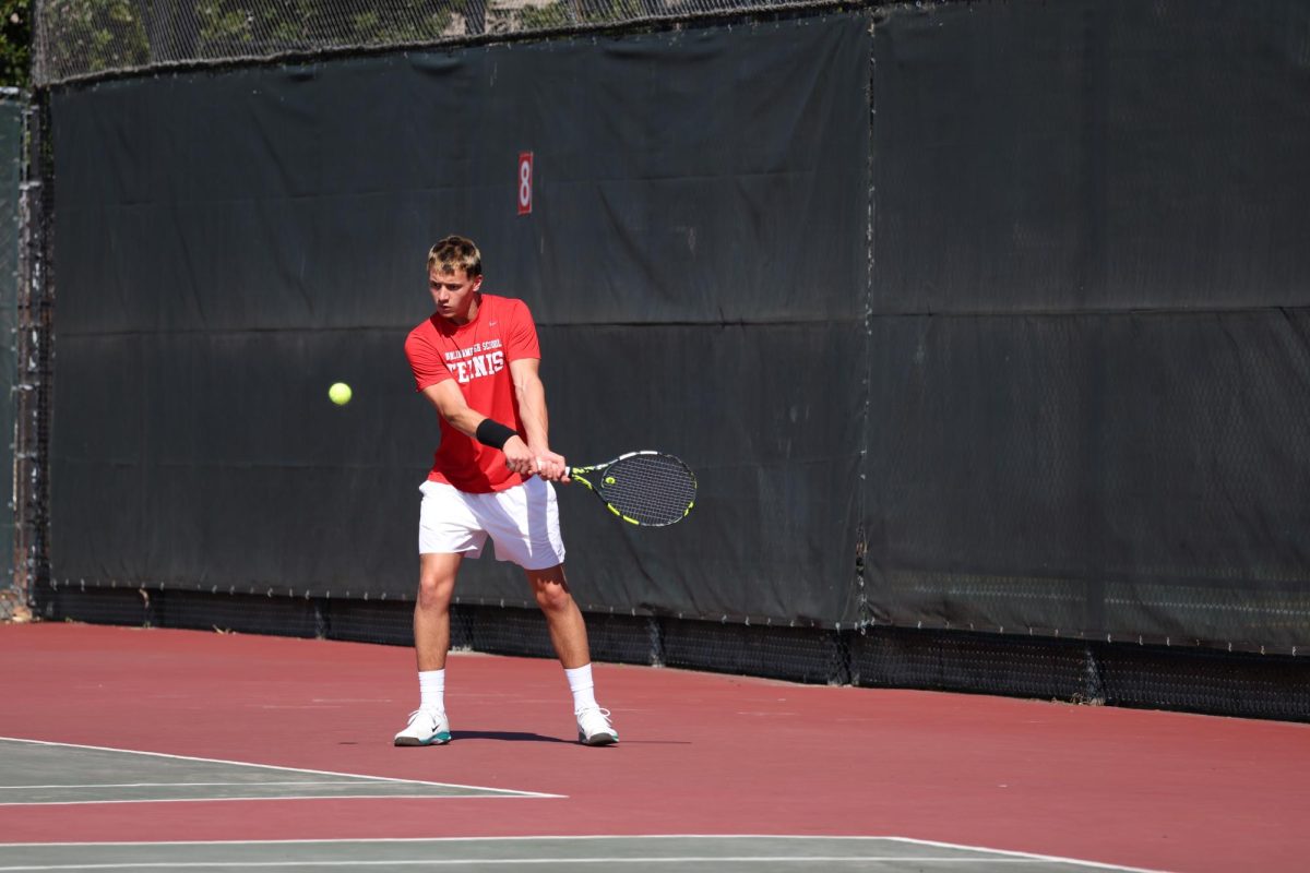 No. 3 singles player senior Alex Bozinovic prepares to hit a backhand to his opponent.