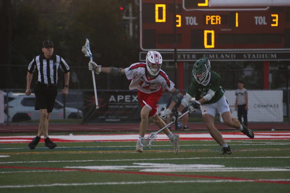 Senior Rowan Maher navigates the ball around Palo Alto’s offense during a scoreless first quarter.