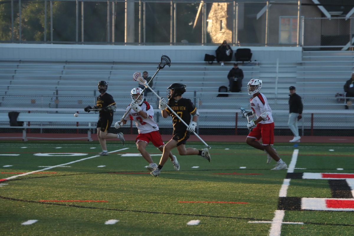 Senior Lucas Kim defends against a Mountain View player, successfully knocking the ball from his stick.