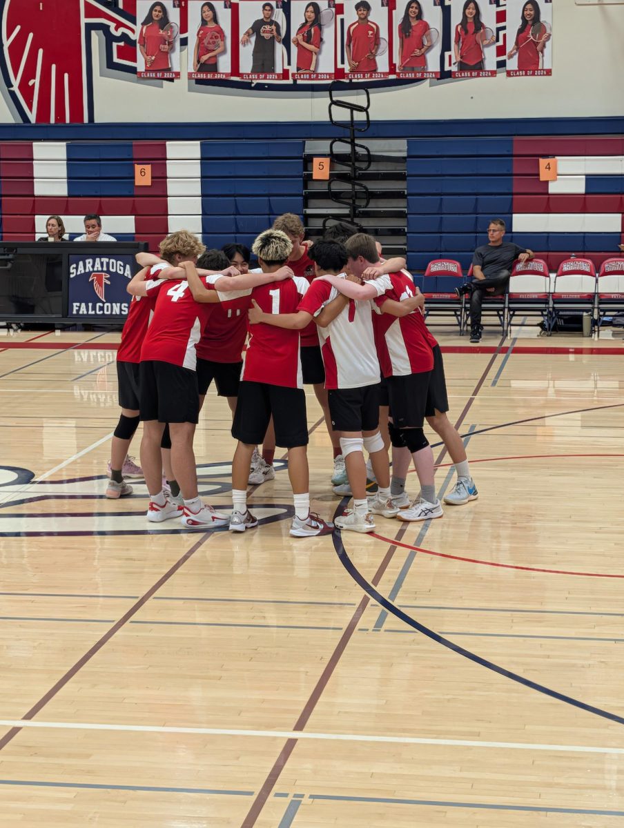 The boys’ volleyball team huddles up to build morale before their match. Photo courtesy of Eric Chiang.
