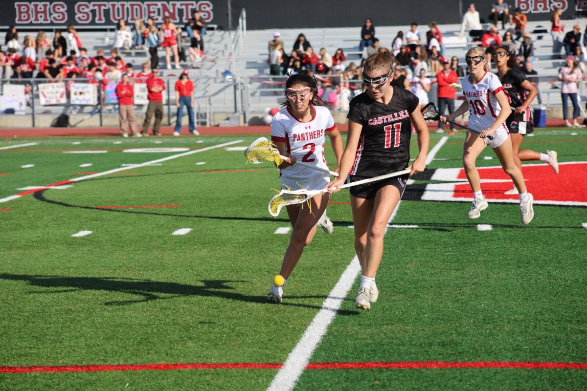 Freshman Elsie Geddes races the opposing player to the ball.