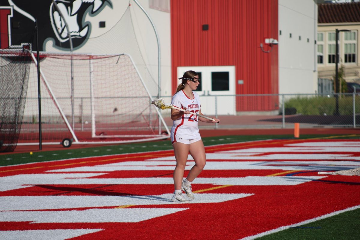 Freshman Audrey Wuebbling looks out towards the field, surveying where her teammates are positioned.