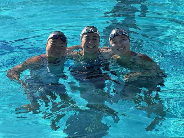 Senior Catherine Kwong, sophomore Abby Zarahn, and junior Alexa Chang pose for a photo in the pool after the girls’ 400-yard freestyle relay final at CCS Championships. Photo courtesy of Helen Foo.
