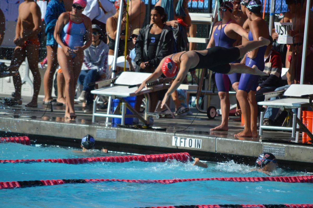 Junior Katelin Huang dives into the water for the third leg of the girls' varsity 200-yard freestyle relay.